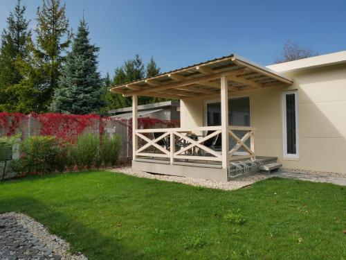 a house with a porch with a wooden fence at COMFORT Rožnov in Rožnov pod Radhoštěm