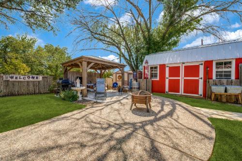 a backyard with a red barn and a patio at Charming Pet Friendly 4 BDRM Home Mins To Main ST and Wineries in Fredericksburg