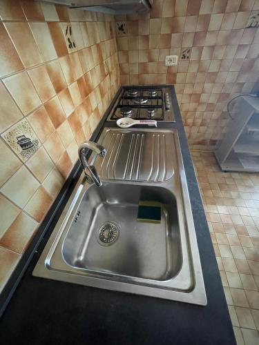 a kitchen with a stainless steel sink and stove at Casa del Sole in Ercolano