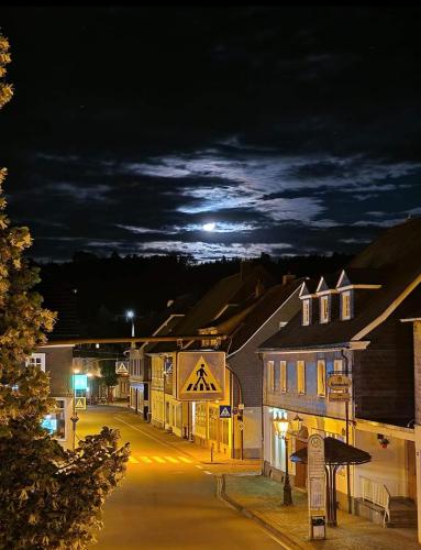 a town at night with the moon in the sky at 3-Zimmer Ferienwohnung Biggesee Sauerland nahe Olpe in zentraler, ruhiger Lage in Drolshagen
