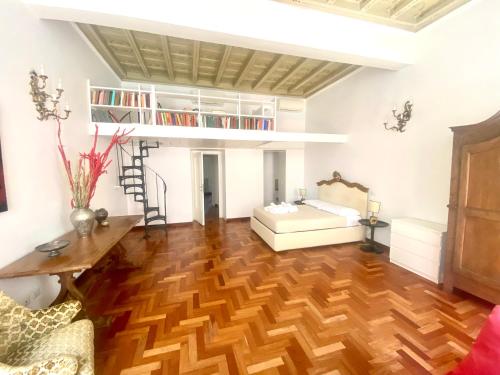 a living room with a loft bed and wooden floors at SWEETSUITE Rome in Rome