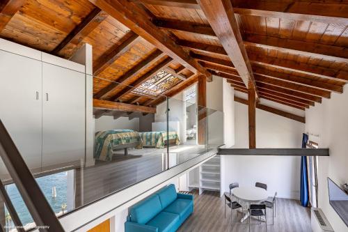 a living room with a blue couch and a table at Casa Romani Lake Apartments in Nago-Torbole