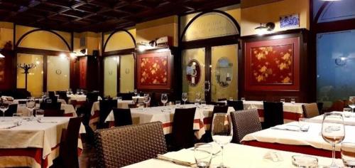 a dining room with white tables and chairs at Hotel Ristorante Aeclanum in Mirabella Eclano