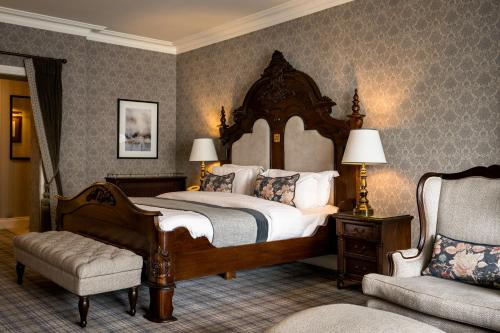 a bedroom with a large bed and a chair at Harvey's Point in Donegal