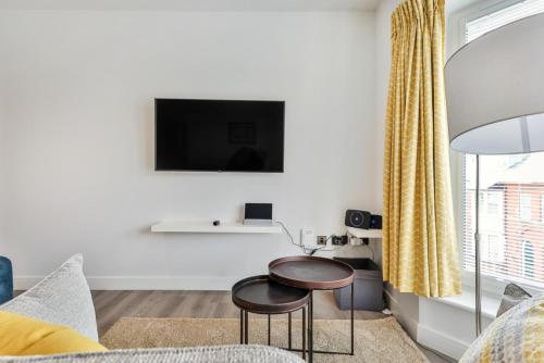 a living room with a table and a tv at Finest Retreats - Belle House, Apt 5 in Filey