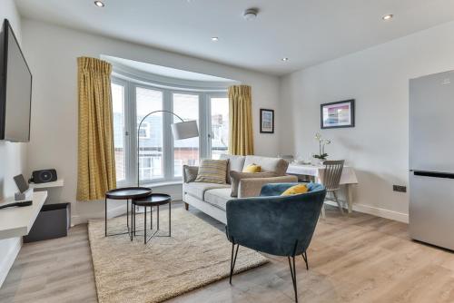 a living room with a couch and a table at Finest Retreats - Belle House, Apt 5 in Filey