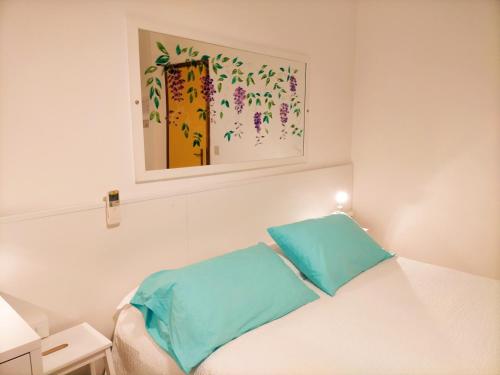 Ένα ή περισσότερα κρεβάτια σε δωμάτιο στο Le Petit Hotel