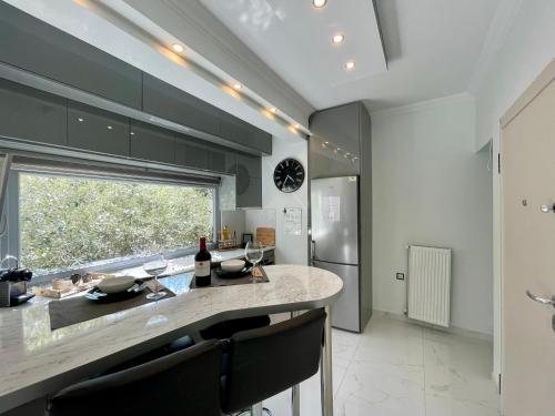 a kitchen with a large island with a counter top at Luxurious Modern Home in Kalamaria, Thessaloniki in Thessaloniki