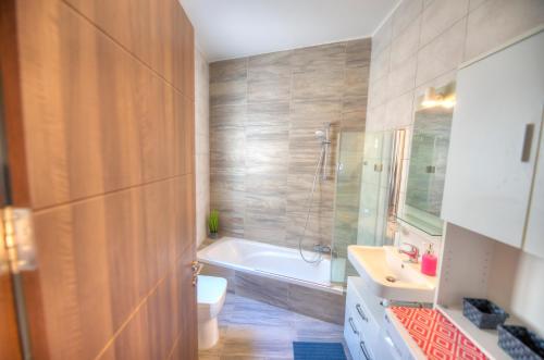 un bagno con vasca, WC e lavandino di Charming 2 bedroom apartment close to Junior College ETUS1-1 a Msida