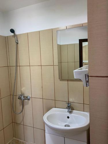 a bathroom with a sink and a shower at Casa Steluta de Mare in 2 Mai