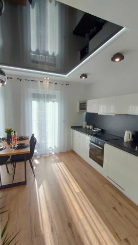 a kitchen with a table and a dining room at Haven Apart Karpacz in Karpacz