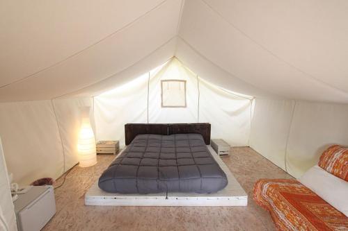Postel nebo postele na pokoji v ubytování Glamping Agricampeggio Tognoni