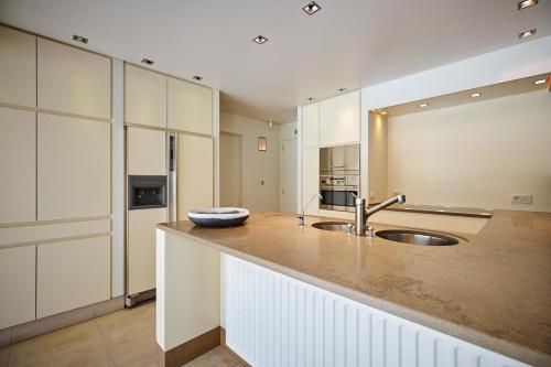 a kitchen with a sink and a counter top at Casa Jacaranda in Westvleteren