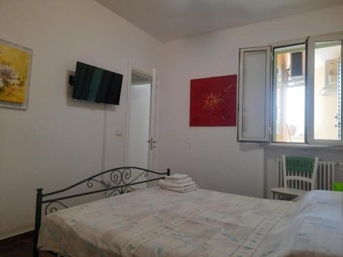 a bedroom with a bed and a television on the wall at Fata Morgana in Casamassella