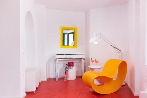 a room with a yellow chair and a table at Avant Garde Suites in Akrotiri