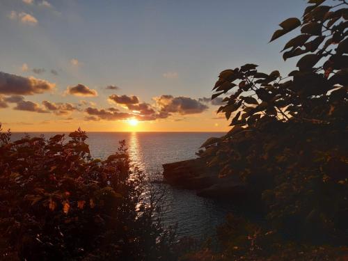a sunset over the ocean with the sun setting at Allure Apartments in Ulcinj