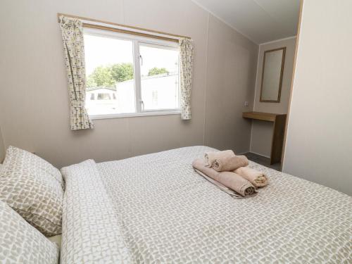 a bedroom with a bed with a towel on it at C22 Par Sands in Par