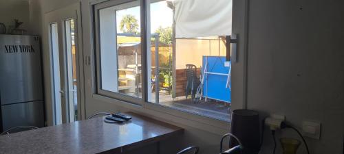a window in a room with a view of a yard at Vaste maison Fouras 15 pers 6 chbres meublé 3* in Fouras