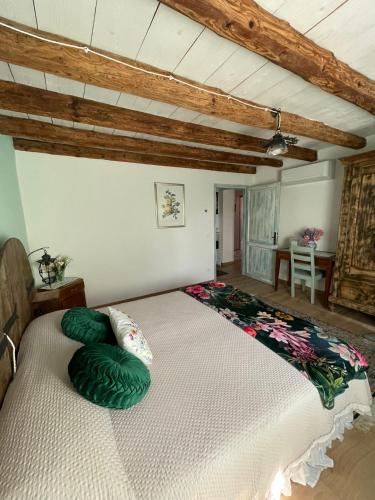 a large bed in a room with wooden ceilings at La Bricola in Cavallino-Treporti