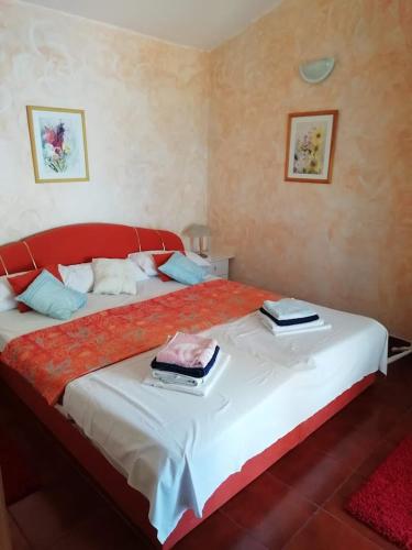 a bedroom with a large bed with two plates on it at Apartment Branko in Drage