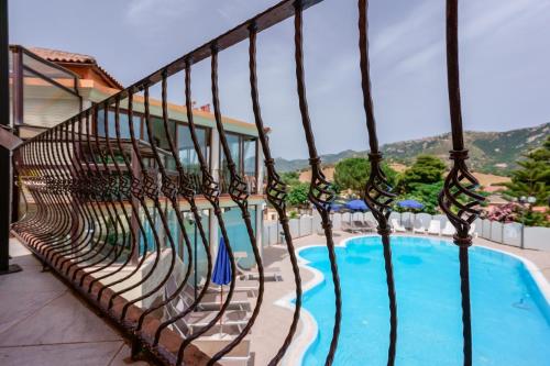 a balcony with chairs and a swimming pool at Hotel Solanas in Solanas