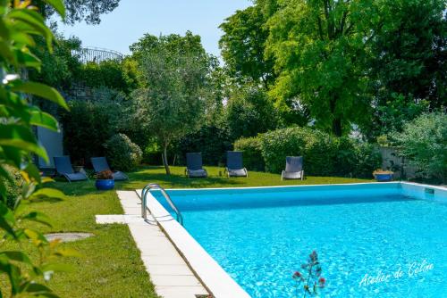 a swimming pool in a yard with lounge chairs at Peaceful retreat in Drome Provencale Castel in Montboucher-sur-Jabron