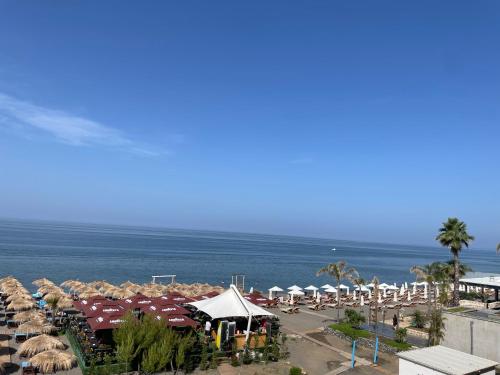 a beach with a bunch of umbrellas and the ocean at Suite Rana Hedhun in Shëngjin