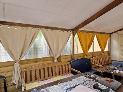 a room with two beds and a table and windows at Vaste maison Fouras 15 pers 6 chbres meublé 3* in Fouras