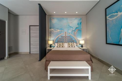 a bedroom with two beds and a painting on the wall at Matteotti Luxury Residence in Siracusa