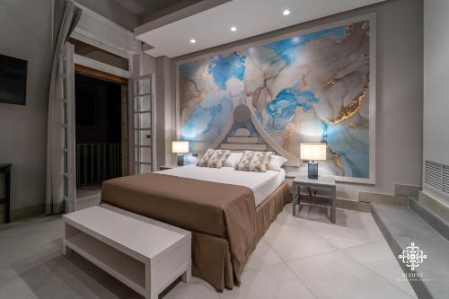 a bedroom with a bed and a painting on the wall at Matteotti Luxury Residence in Siracusa