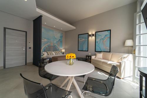 a living room with a table and a couch at Matteotti Luxury Residence in Siracusa