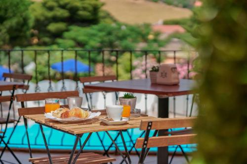 a wooden table with a plate of food on it at Hotel Solanas in Solanas