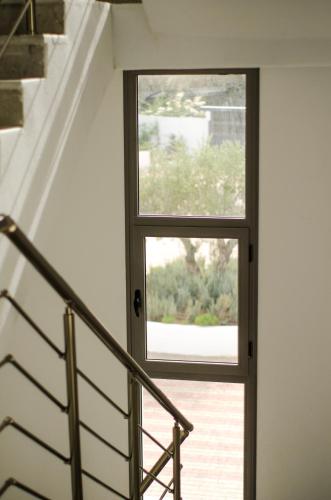 a door with a window in a stair case at Maison des Oliviers, Yasmine Hammamet, Bouficha in Hammamet Sud