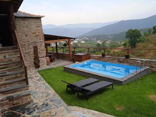 a swimming pool in the yard of a house at Casa da Ana - Um refúgio na montanha in Arouca