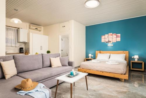 a living room with a couch and a bed at Sea Salt Apartments in Samos