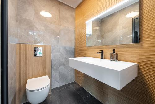 a bathroom with a white sink and a toilet at Villa Maris in Mlini