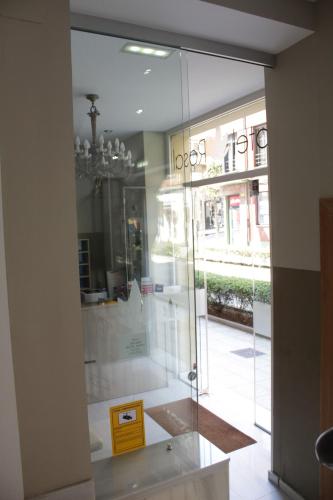 a glass door in a room with a window at Hotel Boutique Rosal Oviedo in Oviedo