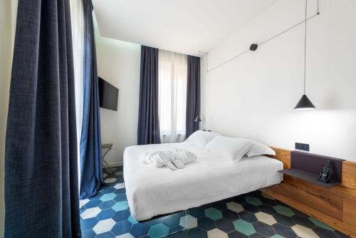 a hotel room with a bed and a window at Villa Fedora Luxury Suites in Lucca
