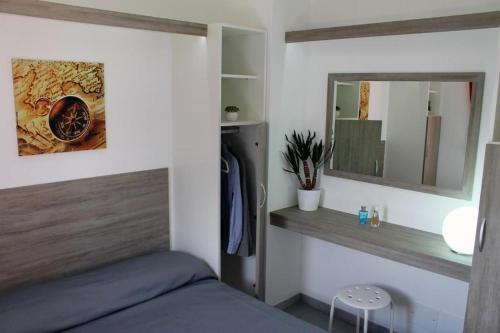 a bedroom with a bed and a mirror at The Camp by Maggiore Suites in Maccagno Inferiore