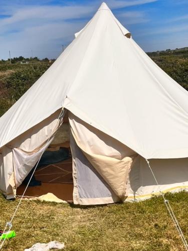 a large white tent sitting in the grass at Gwens Garden bell tent in St. Just