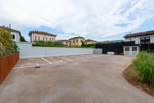 an empty parking lot with houses in the background at Villa Fedora Luxury Suites in Lucca