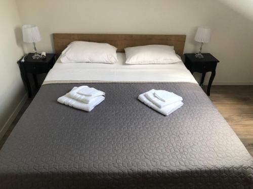 a bedroom with a bed with two towels on it at Apartment CENTRO in Kastav