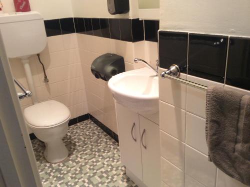 
a bathroom with a toilet and a sink at New Whyalla Hotel in Whyalla
