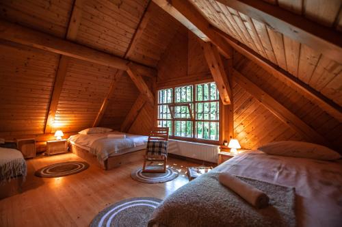 a attic room with two beds and a window at Boutique House Vresje in Bohinjska Bistrica