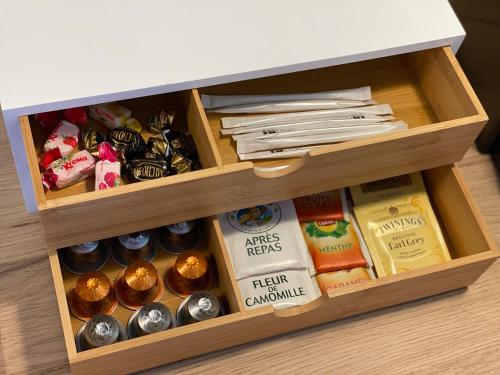 a wooden drawer filled with different types of food at *** Domaine des Noyers - Proche centre Ville in Châteauneuf-sur-Loire
