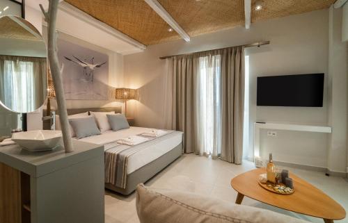 a bedroom with a bed and a living room at TIS YAYAS apartments in Pylos