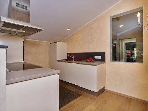 a kitchen with white cabinets and a counter top at A-VITA Viktoria & A-VITA living luxury apartments in Seefeld in Tirol