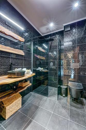 a bathroom with a sink and a glass shower at Black Box Studio in Smolyan