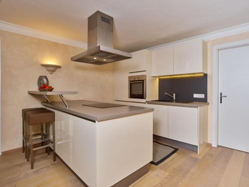 a kitchen with white cabinets and a counter top at A-VITA Viktoria & A-VITA living luxury apartments in Seefeld in Tirol