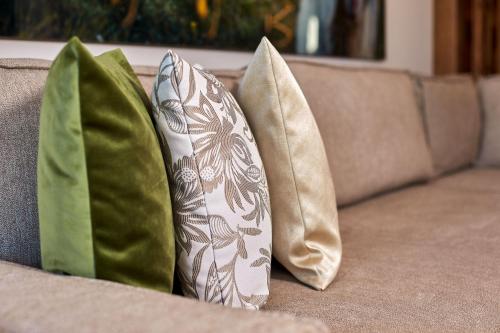 three pillows sitting on top of a couch at A-VITA Viktoria & A-VITA living luxury apartments in Seefeld in Tirol